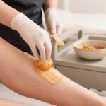 Sugar waxing paste applied to skin during professional hair removal
